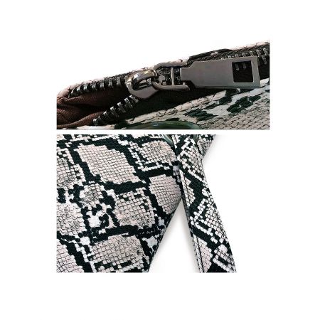 Détail en gros plan de la fermeture éclair métallique sur le sac à main en motif de peau de serpent.