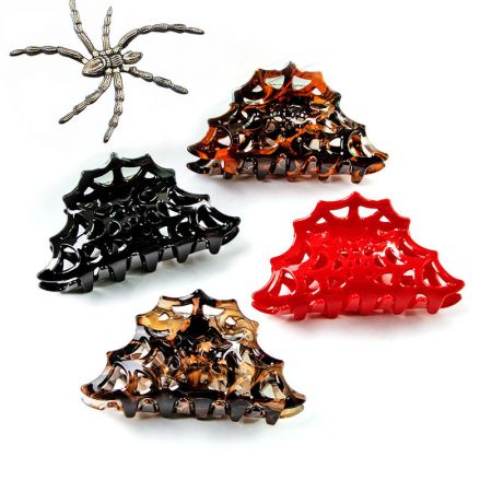 Four spider web hair clips in different colors with a decorative spider.