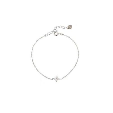 A flat lay of the four-leaf clover anklet, perfect for vacation and beach-themed jewelry collections.