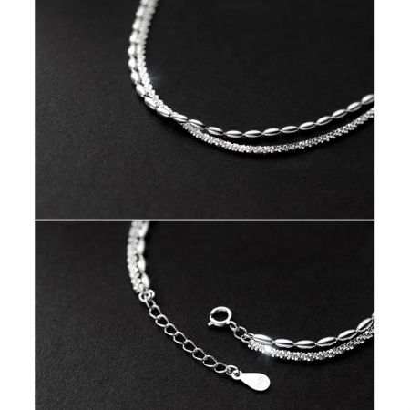Close-up view of the bracelet's clasp and the '925' sterling silver quality mark, with a crystal-accented chain.