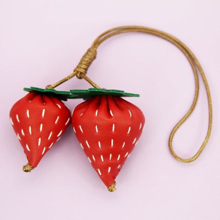 A set of strawberry-shaped PU leather charms, perfect for use as bag accessories or keychains.