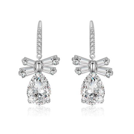 White CZ Oval Drop Bow Earrings - Front view of the White CZ Oval Drop Bow Earrings, featuring a large teardrop-shaped cubic zirconia stone set in rhodium-plated brass with a delicate bow detail.