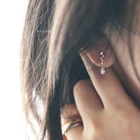 Close-up detail of the micro-inlaid zircon and teardrop crystal on the 925 silver earring.