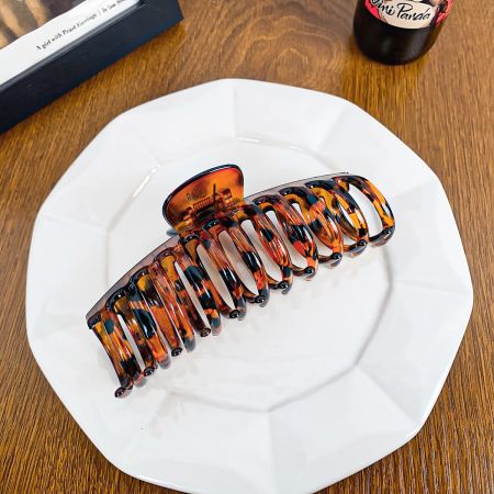 Close-up of a classic tortoiseshell pattern hair claw clip.