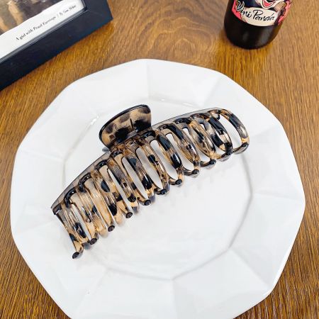 The trendy leopard print hair claw clip, perfect for a bold look.