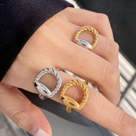 Hand modeling a set of twisted oval stainless steel rings.