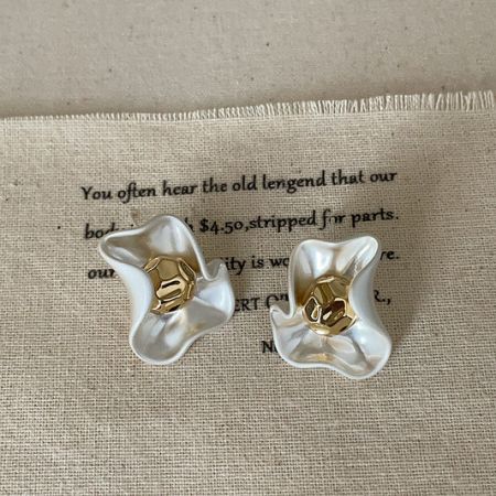 Elegant white petal flower stud earrings with polished gold centers, showcasing vintage-inspired brass jewelry design.
