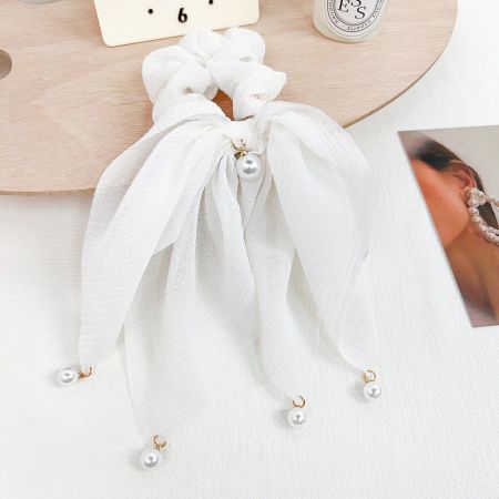 A classic white hair accessory with sophisticated pearl embellishments.