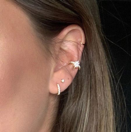 A model showcasing the layered look of the Sunburst Huggie Earrings Set.