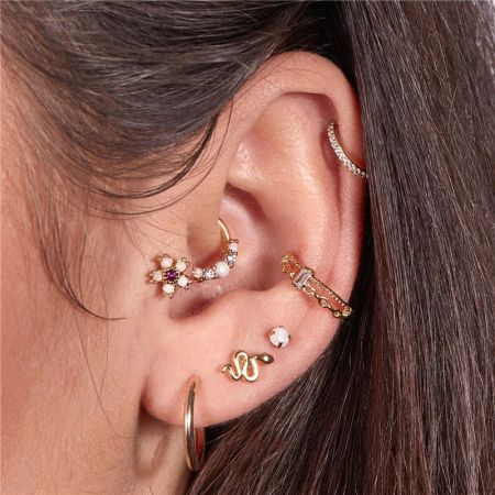 A close-up view of the opal hoop earrings worn in a cartilage piercing, demonstrating their versatile and chic appeal.
