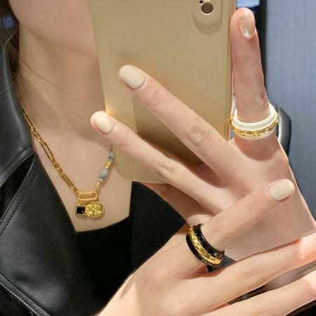 Lifestyle image of a woman wearing the vintage enamel rings.