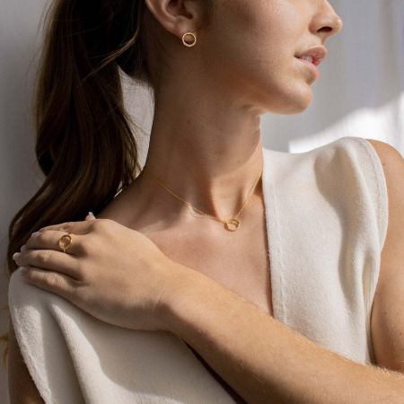Model wearing the elegant 925 sterling silver circle pendant necklace, showcasing its dainty style with a casual outfit.