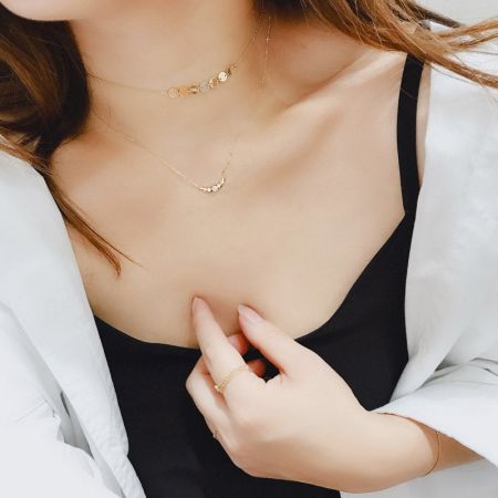 Model wearing the 925 sterling silver smile disc necklace, demonstrating its elegant look.