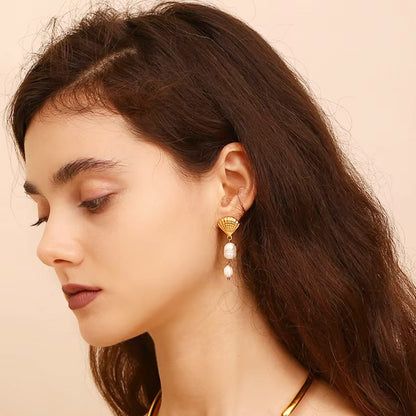 A model wearing the gold shell tassel baroque pearl drop earrings to showcase their elegant look.