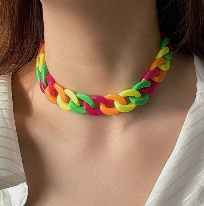 A vibrant Rainbow Oversized Acrylic Chain Necklace with chunky, multi-colored links and gold-plated hardware, displayed on a neutral background.