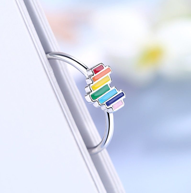A close-up of the Rainbow Heart Ring in 925 sterling silver, featuring a vibrant multi-color enamel heart design.