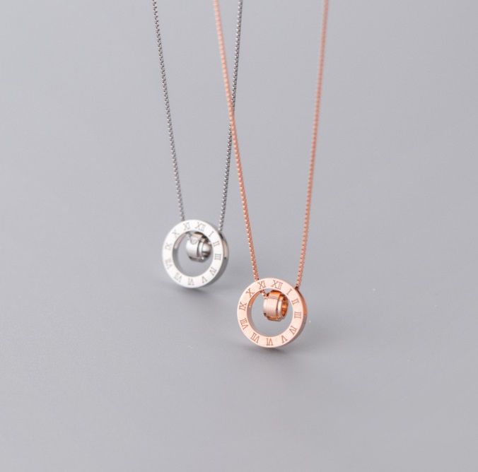 A stunning 925 Sterling Silver Roman Numeral Pendant shown in both polished silver and elegant rose gold finishes, highlighting its versatile and timeless design.