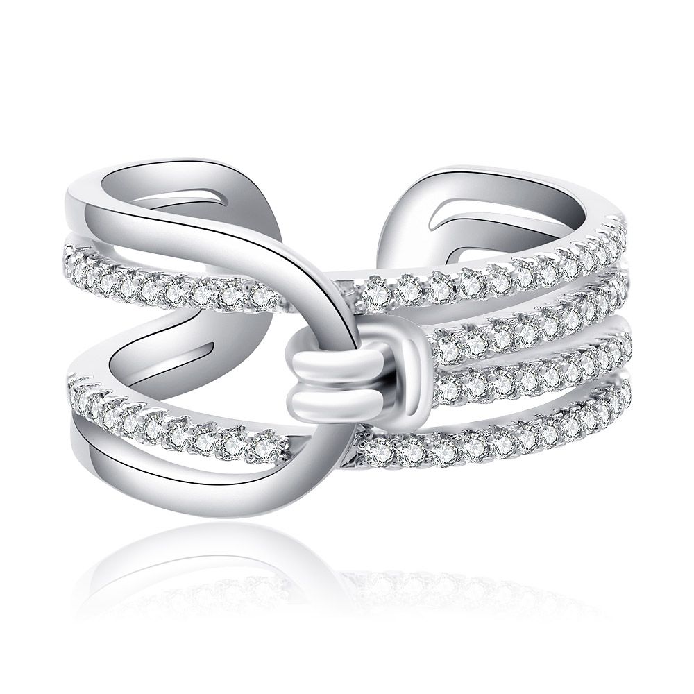 Close-up of a rhodium-plated knot statement ring with a bow-like design, featuring three parallel bands and a central knot adorned with sparkling cubic zirconia stones.