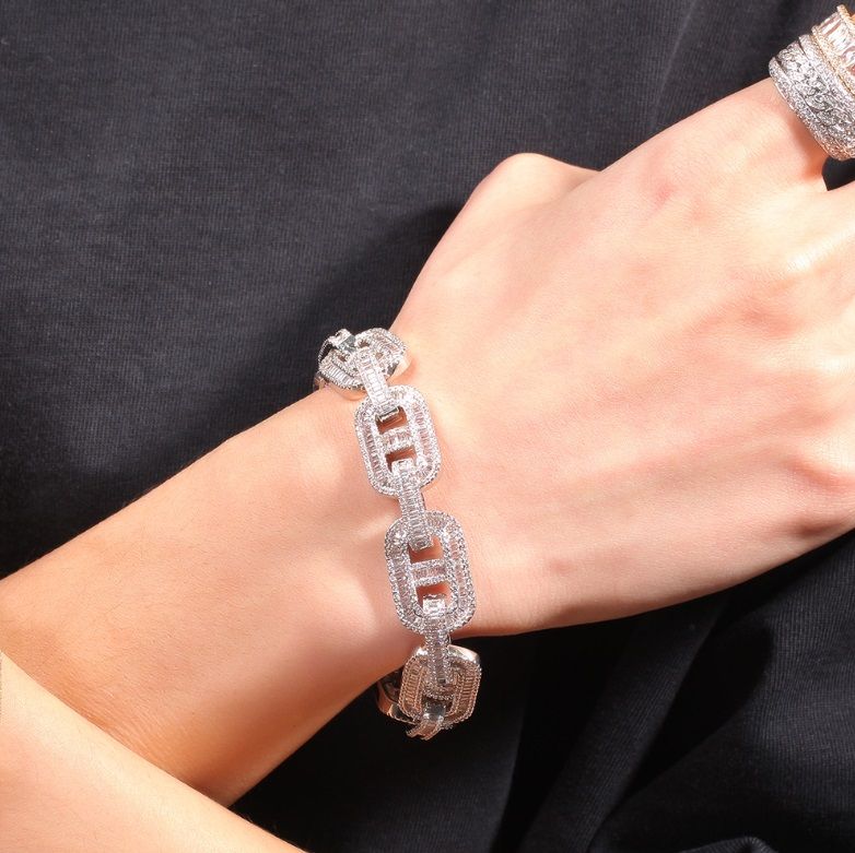 A stylish silver hip hop luxury bracelet with matching rings displayed on a black background, offered by JR Fashion Accessories.