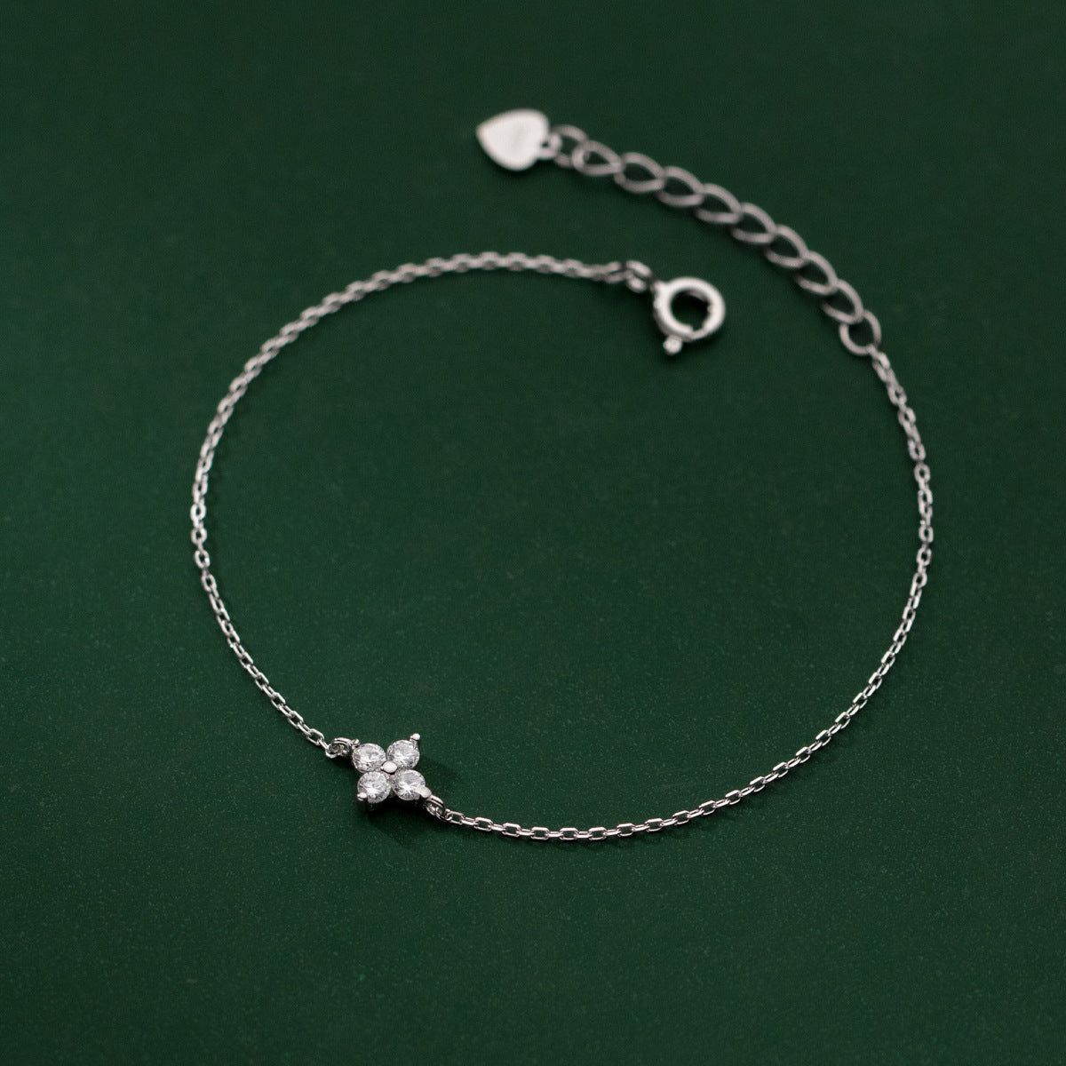 A close-up of the 925 sterling silver four-leaf clover flower charm bracelet, showcasing the delicate chain and lucky clover design.