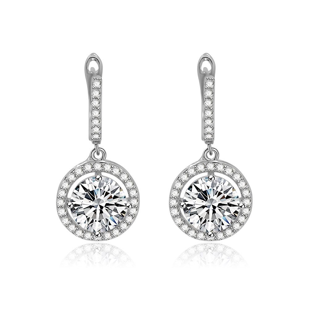 A close-up of the Clear CZ Halo Round Drop Earrings, showcasing the silver circular pendant with a large central cubic zirconia surrounded by a halo of smaller stones.