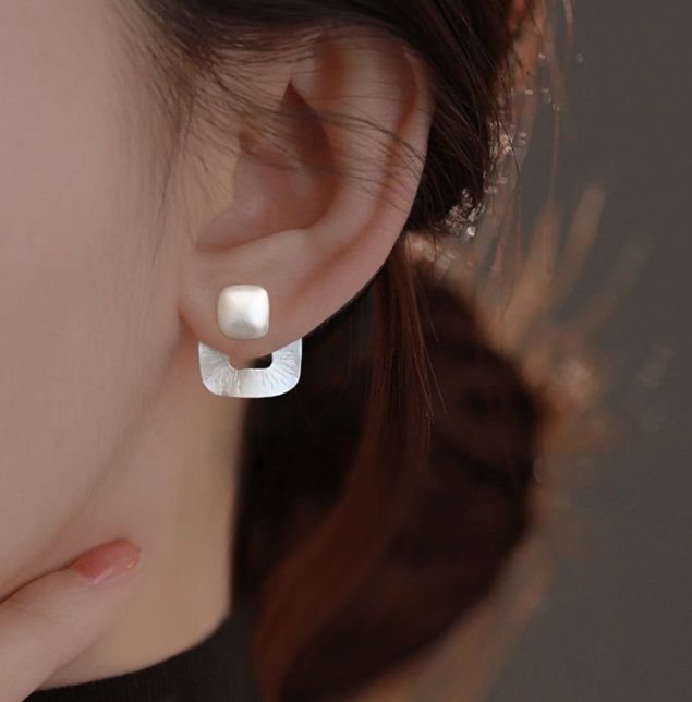 Una foto dettagliata in studio degli Orecchini Quadrati Dichiarativi in Argento Sterling 925, evidenziando il design geometrico e la finitura in argento lucido.