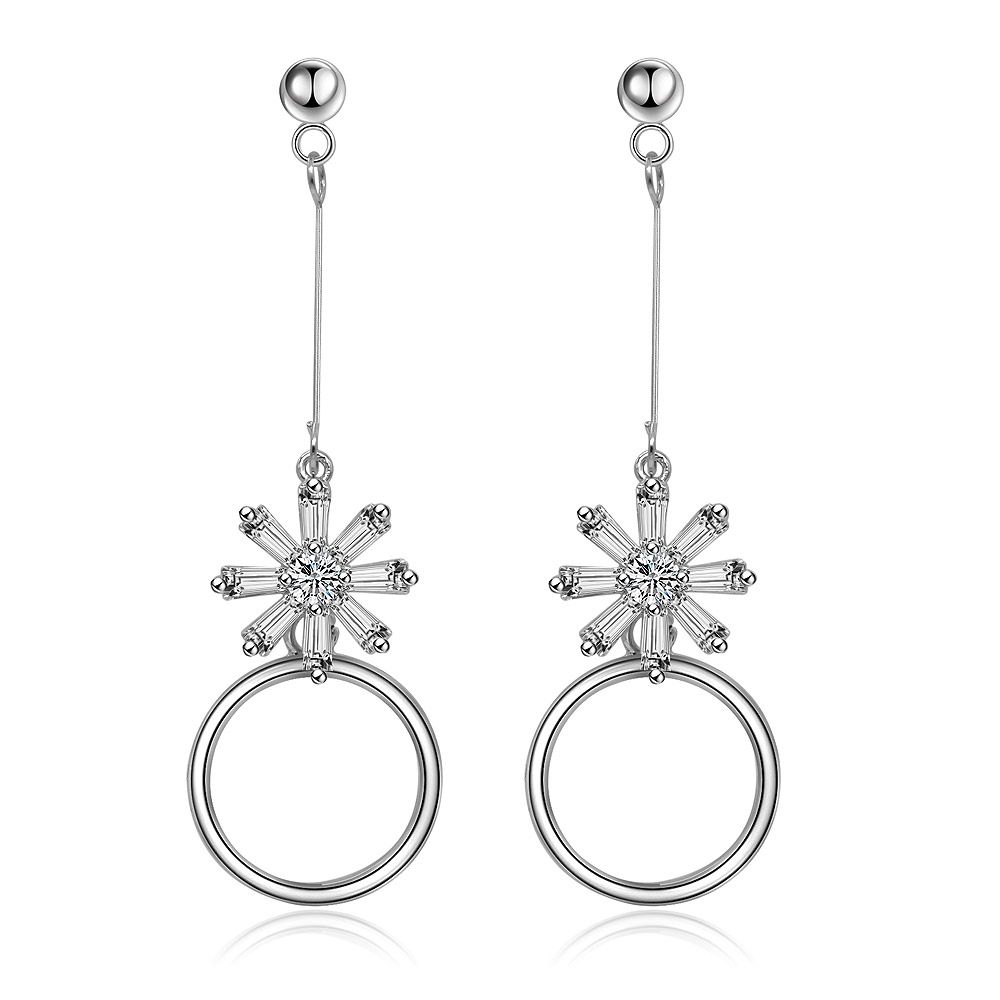 Elegant silver dangle earrings featuring a flower-like cluster of baguette and central cubic zirconia stones, with a large open hoop.