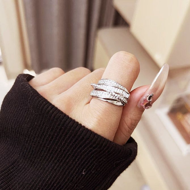 A model's hand showcasing the adjustable open multi-layered cubic zirconia brass rings, highlighting their elegant design and fit.