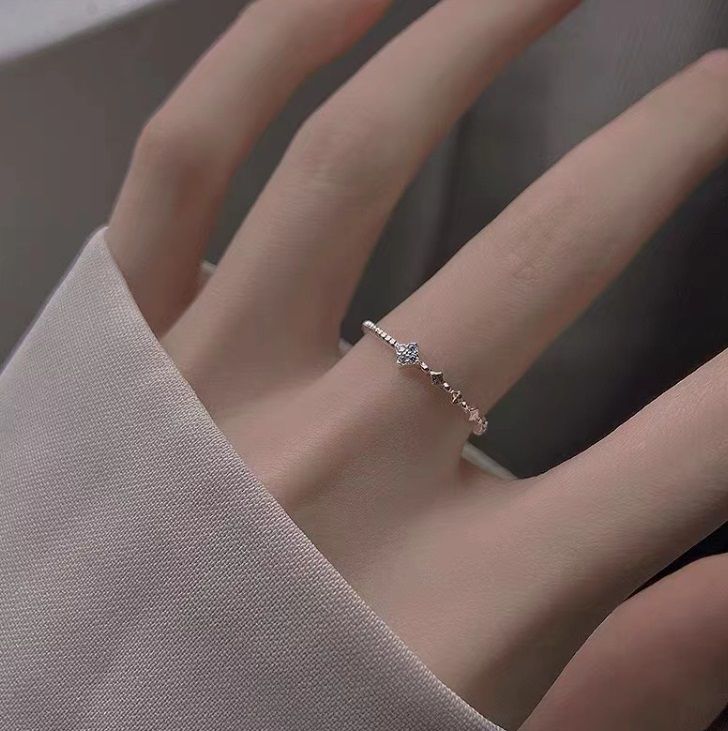 A close-up product shot of the 925 Sterling Silver Clover Leaf Stacking Ring, showcasing its intricate design and sparkling central gemstone.
