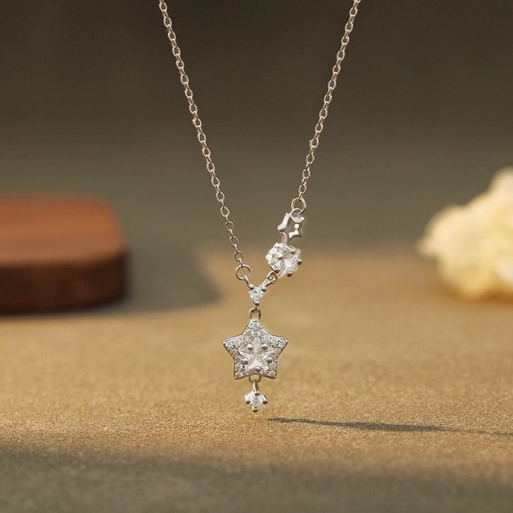 A delicate 999 sterling silver necklace with a sparkling star-shaped pendant on a clean white background, showcasing its celestial design.