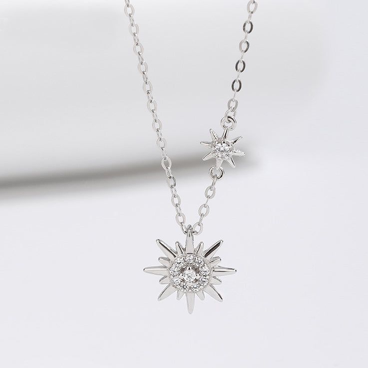 A detailed studio shot of the 925 sterling silver sparkling starburst double sun necklace, showcasing its two intricate pendants with clear gemstones.