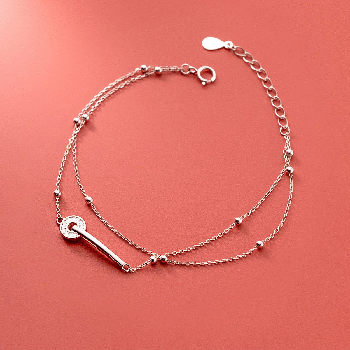 A close-up of a wholesale 925 sterling silver double-strand bead chain bracelet, featuring an elegant toggle clasp.