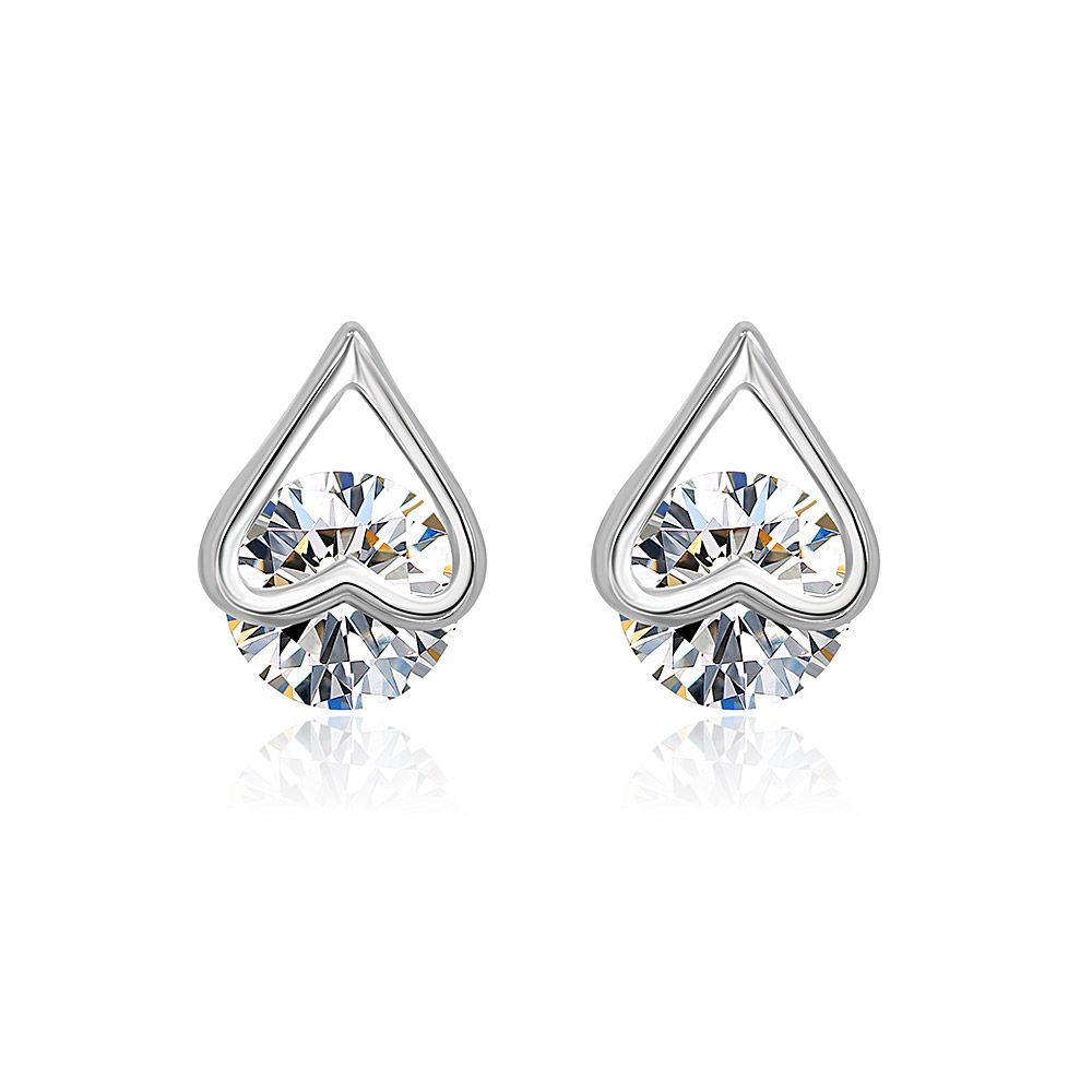 A close-up studio shot of Silver Heart Ear Studs with a single, brilliant-cut cubic zirconia stone, showcasing the rhodium-plated brass finish.