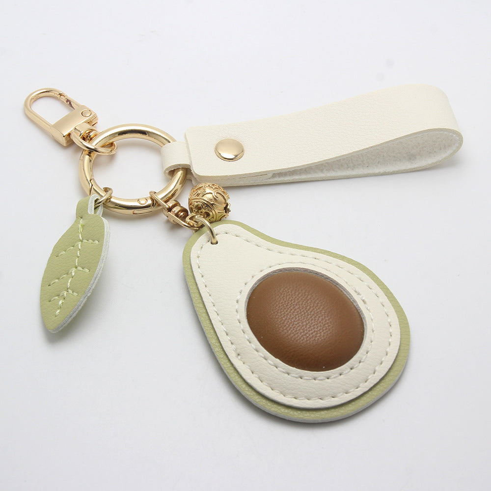 Wholesale PU leather avocado keychain with a wristlet strap, perfect as a cute bag charm for resale.
