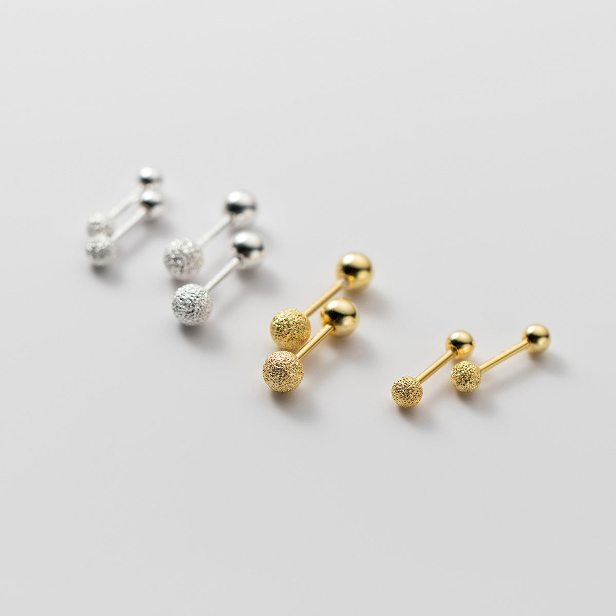 A collection of 925 sterling silver double ball stud earrings, displayed in both silver and gold finishes.