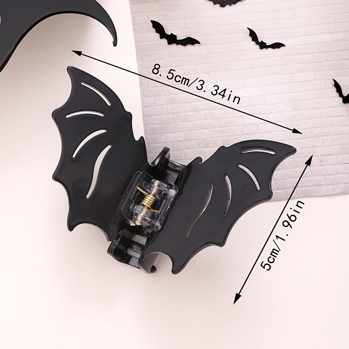 A black bat-shaped hair claw clip with a detailed hollow-out design, ideal as a non-slip horror accessory for Halloween.