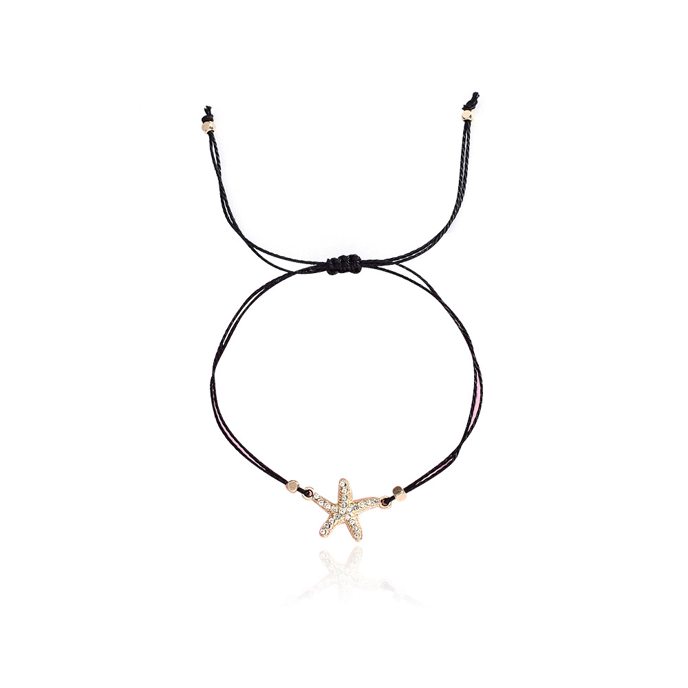 A stylish black cord bracelet featuring an elegant gold-plated starfish charm with sparkling crystal accents, displayed on a white background.