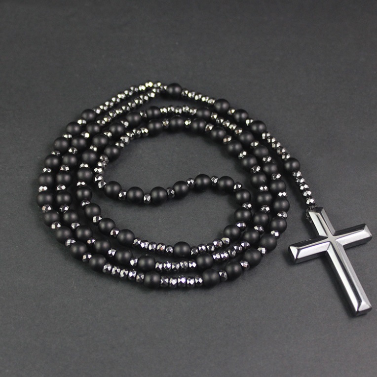 Detailed view of a custom black beaded rosary necklace with a polished sterling silver cross pendant, manufactured by JR Fashion Accessories.