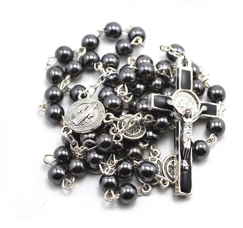 A custom black rosary necklace featuring silver details, a crucifix, and a religious medal, showcasing the fine craftsmanship of JR Fashion Accessories.