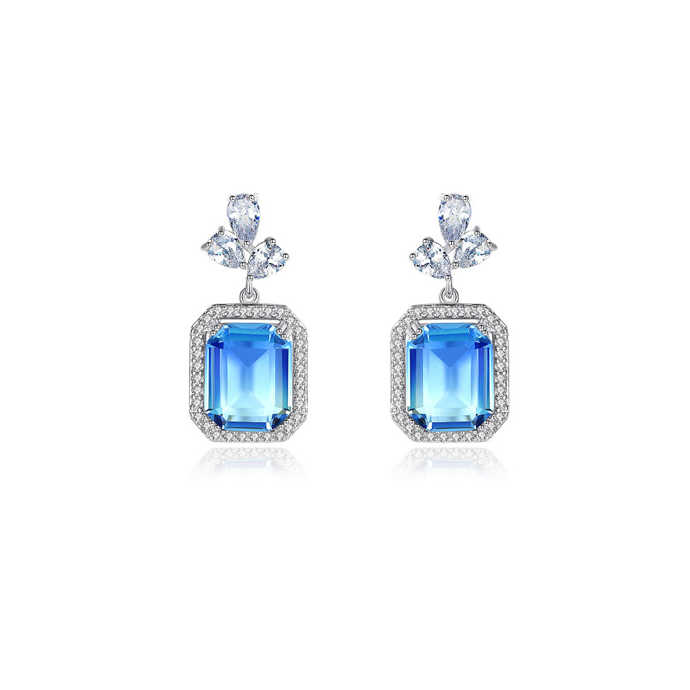 A pair of Vitrail Light Stone Wedding Earrings featuring large rectangular blue gemstones surrounded by sparkling AAA-grade cubic zirconia.