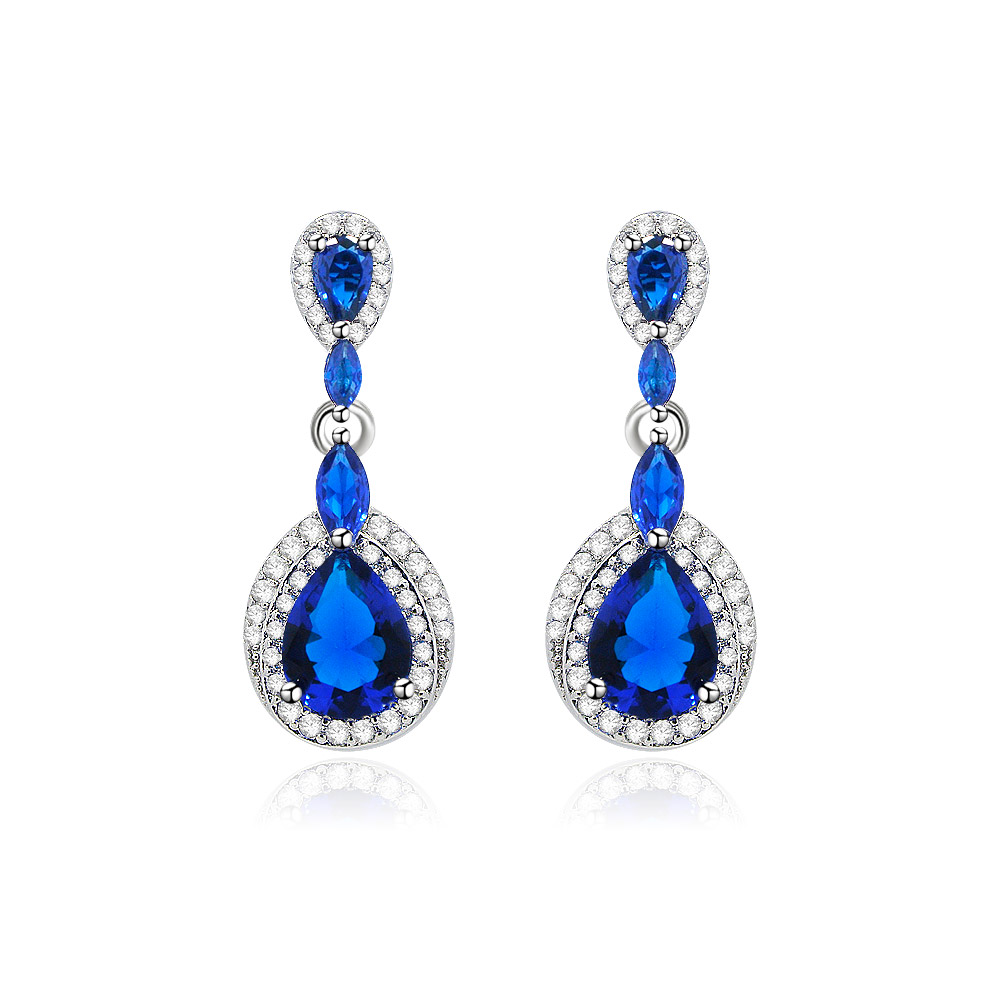 Tear Drop Pear Cubic Dangle Earrings featuring blue sapphire glass and white cubic zirconia in a rhodium-plated setting, shown against a white background.
