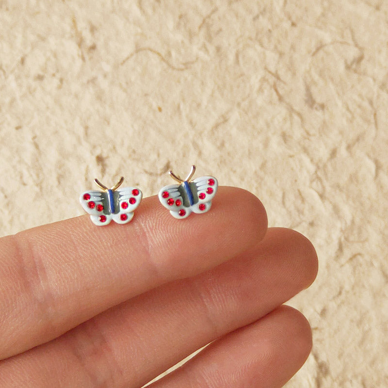 A pair of vintage-style mini butterfly stud earrings with colorful enamel details, crafted from 14k gold-plated brass.