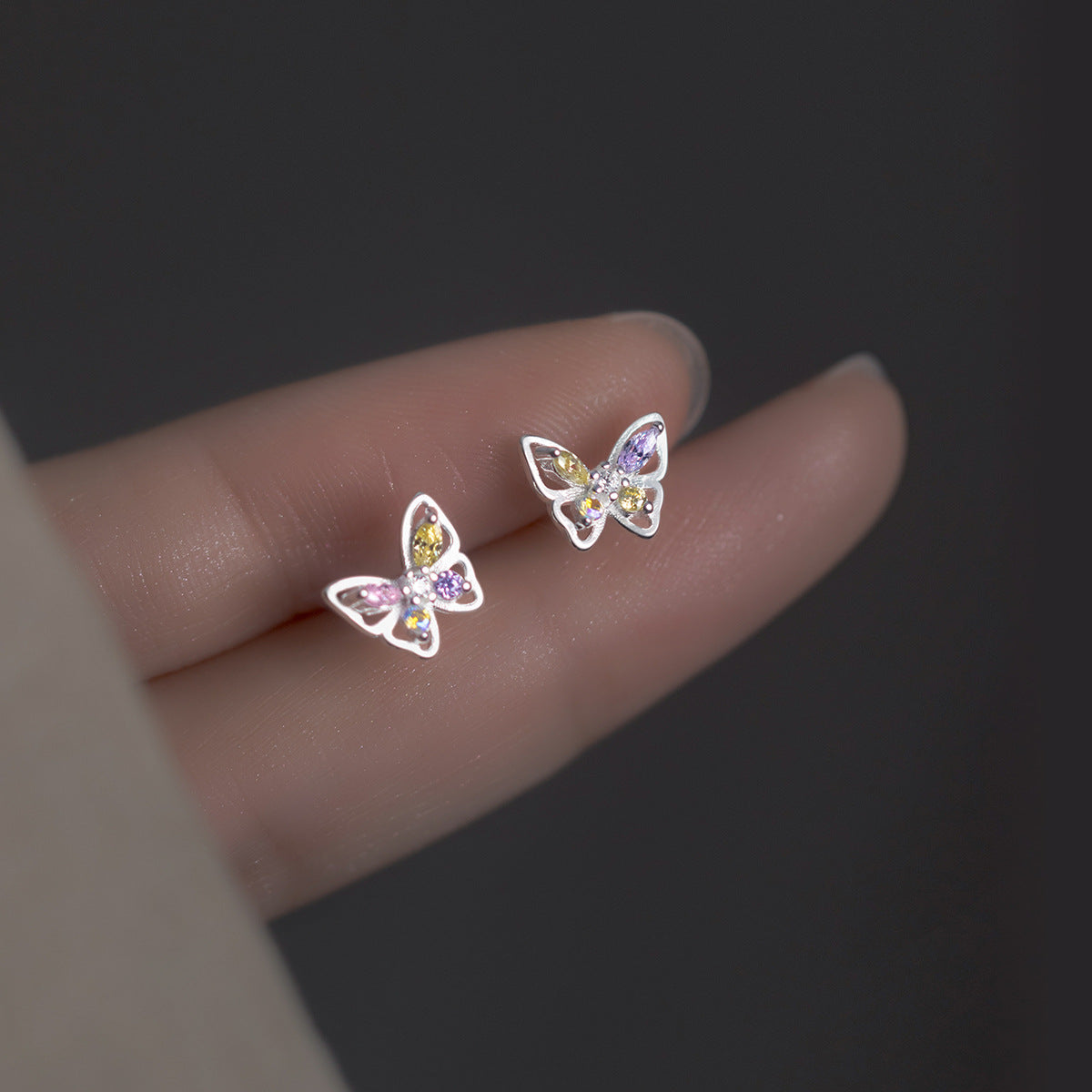 A set of five pairs of 925 sterling silver butterfly stud earrings with vibrant multicolor cubic zirconia stones.