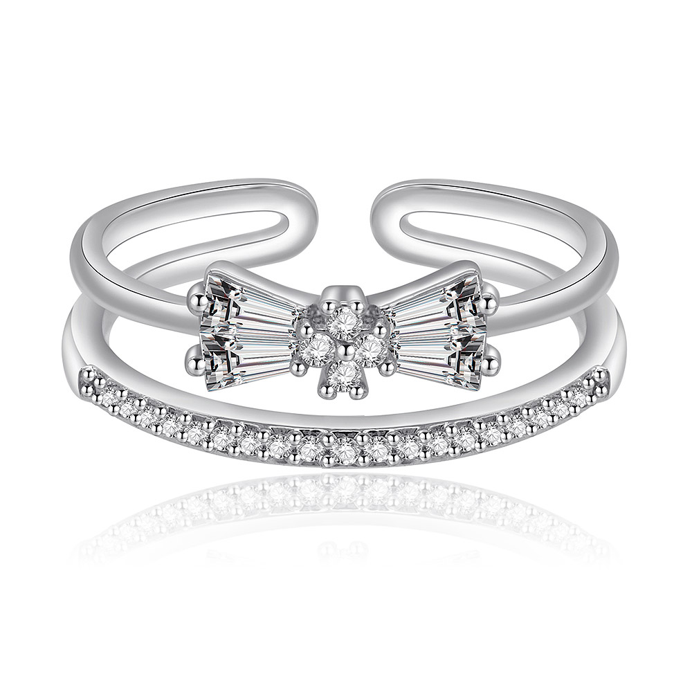 A close-up of the Glamorous Bow Ring, featuring a delicate bow design crafted from rhodium-plated brass and intricately set with sparkling cubic zirconia stones.