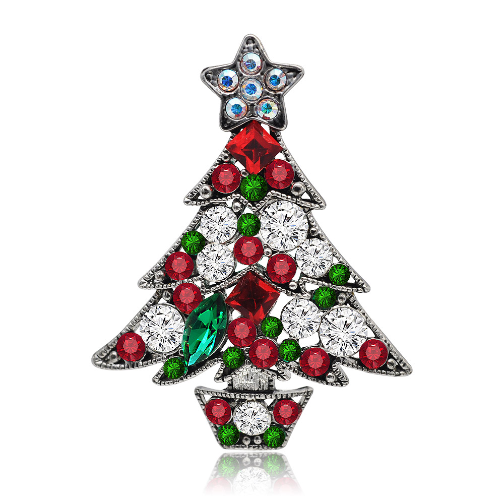 A detailed vintage Christmas tree brooch with black hematite plating, adorned with sparkling multicolored crystals in red, green, and white, and topped with a star.