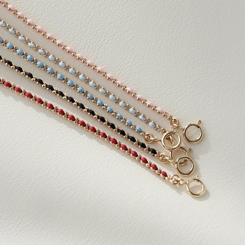 A set of five 925 sterling silver braided cord bracelets in vibrant colors including pink, blue, black, and red, each with an 18K gold-plated bar accent.