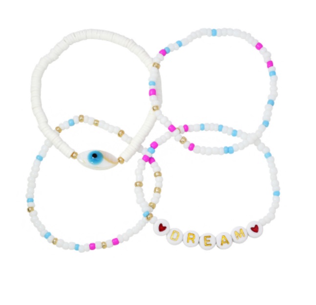 A vibrant set of four colorful beaded bracelets, including one with 'DREAM' in gold letters and another featuring a protective blue evil eye charm.