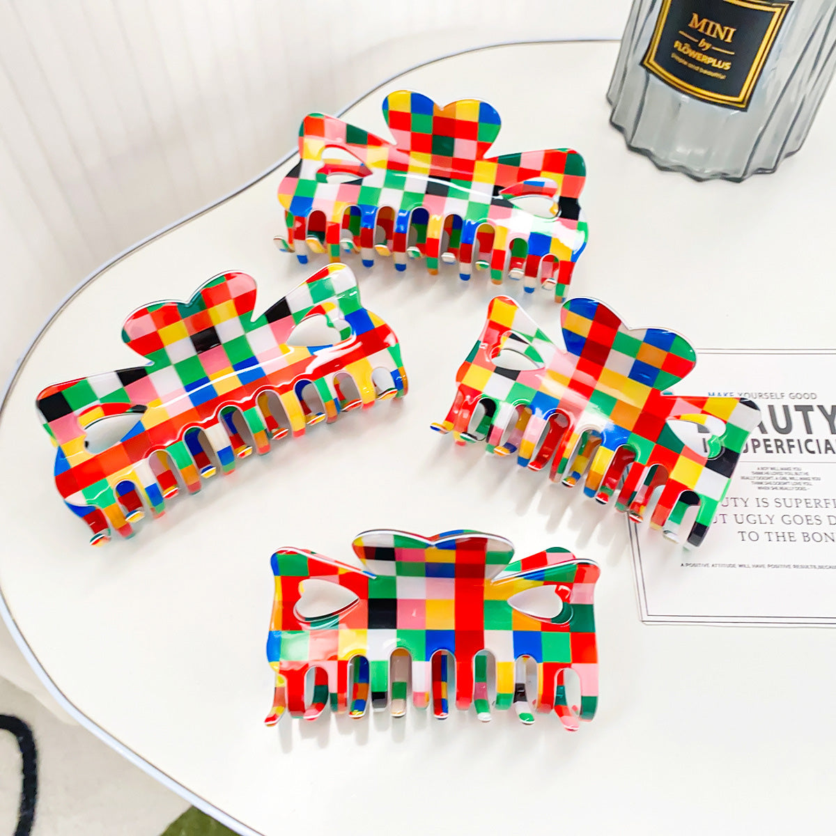 A set of five colorful retro chessboard style hair claw clips with a unique bow design, displayed on a clean white surface.
