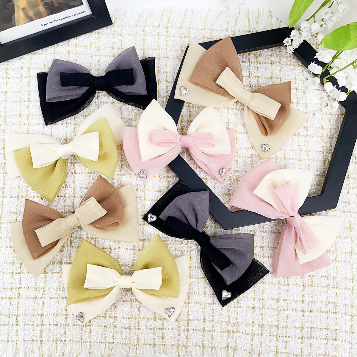 A vibrant collection of wholesale double-color ribbon bow hair pin clips in various colors and designs, neatly arranged for display.