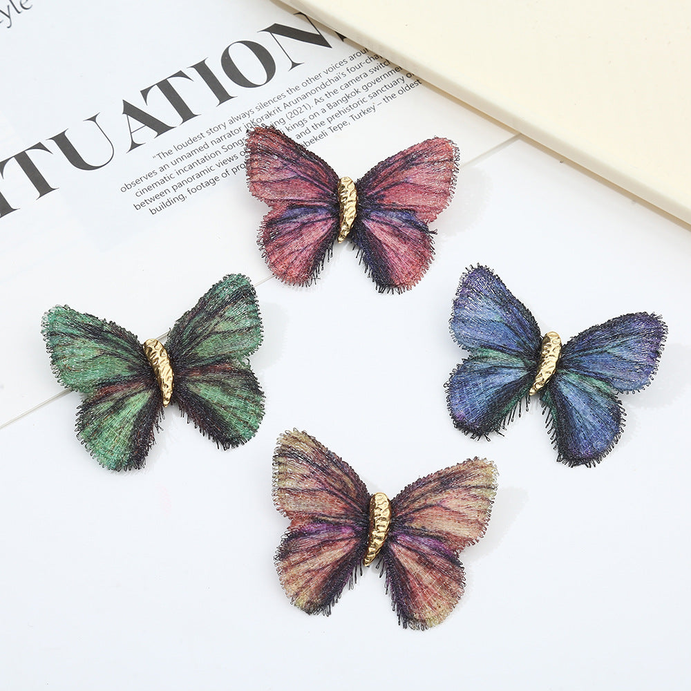 A set of four Gradient Embroidered Vintage Butterfly Brooches in blue, green, pink, and multicolor, showcasing detailed wing embroidery and gold bodies.